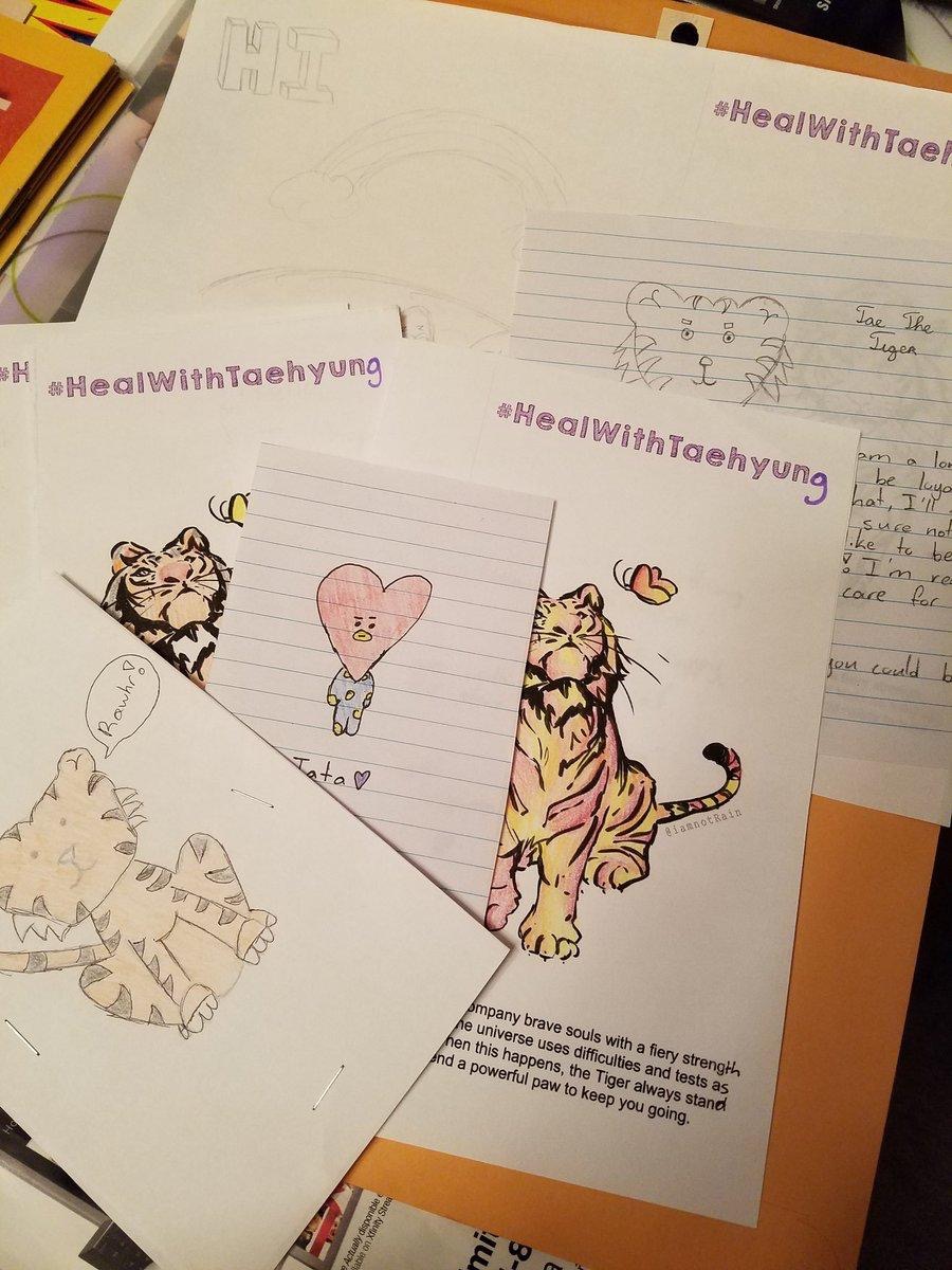 Photo showing printed out colouring pages of tigers. There are also some hand drawn pictures of tigers and BT21 character Tata.