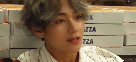 Gif of Taehyung from the shoulders up. His hair is a grown out, silver, messy bowl cut with a part in the middle in the bangs. He's wearing a white dress shirt with thin, brown, vertical stripes. He leans forward and smiles in an open-mouthed, boxy smile. His eyes close the more he smiles.