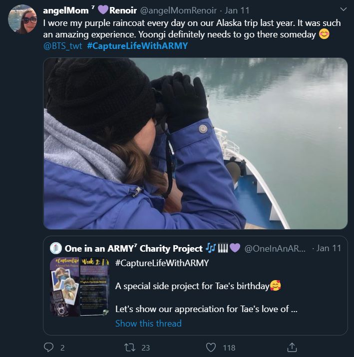 Tweet from an ARMY participating in the Bonus Mission Capture Life With ARMY. Photo shows the ARMY wearing a purple raincoat and using binoculars to look over the edge of a boat on a body of water in Alaska.