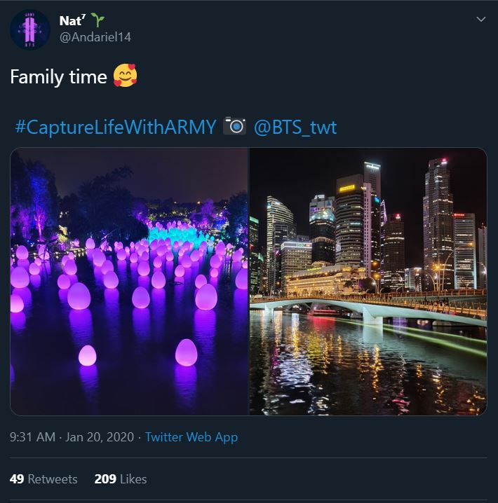 Tweet from an ARMY participating in the Bonus Mission Capture Life With ARMY. The tweet shows two photos, one of purple lanterns casting a soft purple glow on a lake at night, and one of a modern looking concrete bridge crossing a body of water. Behind the bridge are tall apartment or commercial towers that are lit up against the black of night.