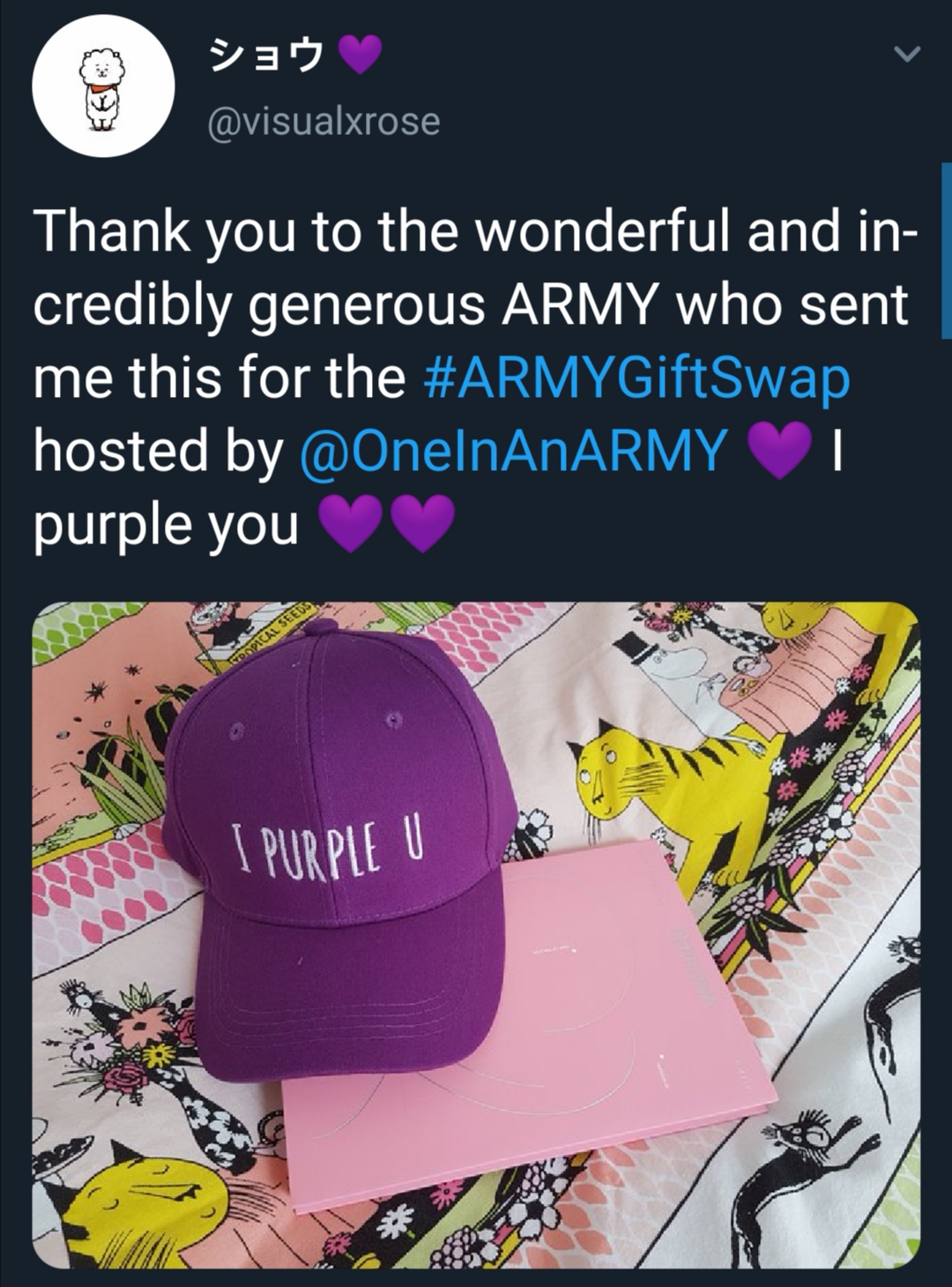 Tweet that shows what an ARMY received from the ARMY Gift Swap. Photo shows a purple ballcap with the words "I purple u" embroidered in white as well as a copy of BTS' album Map of the Soul : Persona