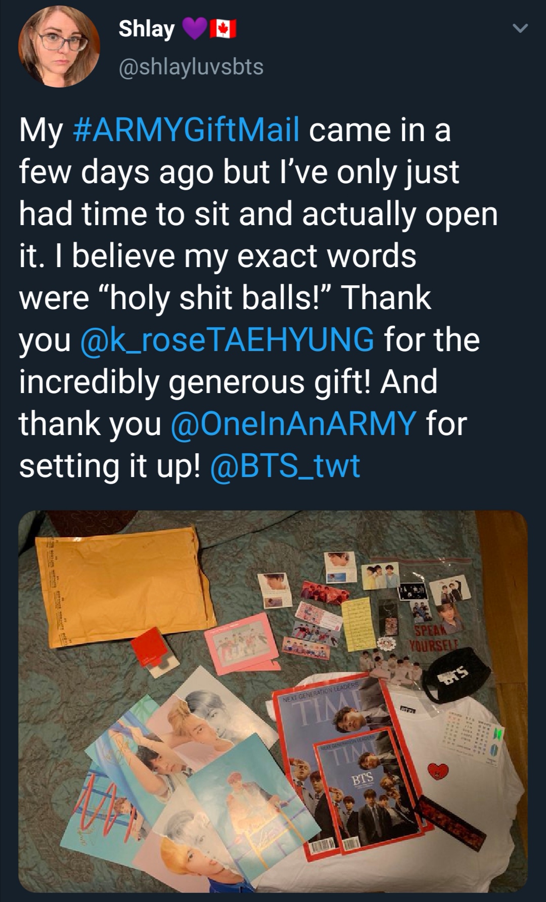 Tweet that shows what an ARMY received from the ARMY Gift Swap. Photo shows a copy of TIME magazine with BTS on the cover, a black facemask with the word BTS on it, and a number of small posters and photos