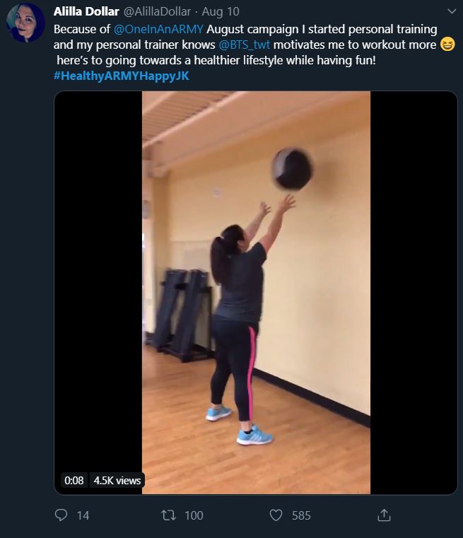 Tweet showing an ARMY participating in the bonus mission Healthy ARMY Happy Jungkook. The tweet says the ARMY started using a personal trainer. The still frame from the attached video shows the ARMY from the back, bouncing a weighted ball against a gym wall.