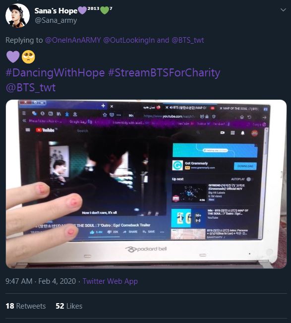 Screenshot of a tweet that shows an ARMY streaming the Ego music video. They're hovering three fingers in front of the computer screen.